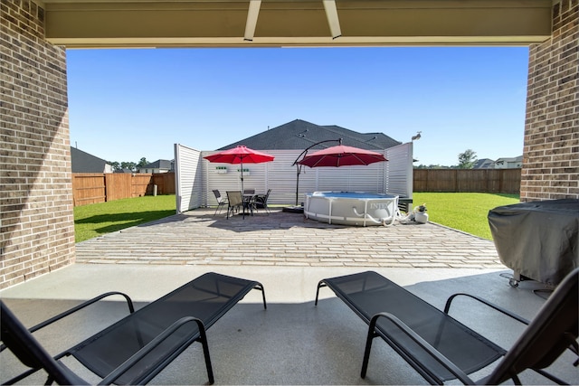 1827 Woodtrace Blvd, Pinehurst, TX 77362 - view of patio / terrace with a jacuzzi, outdoor dining space, and area for grilling