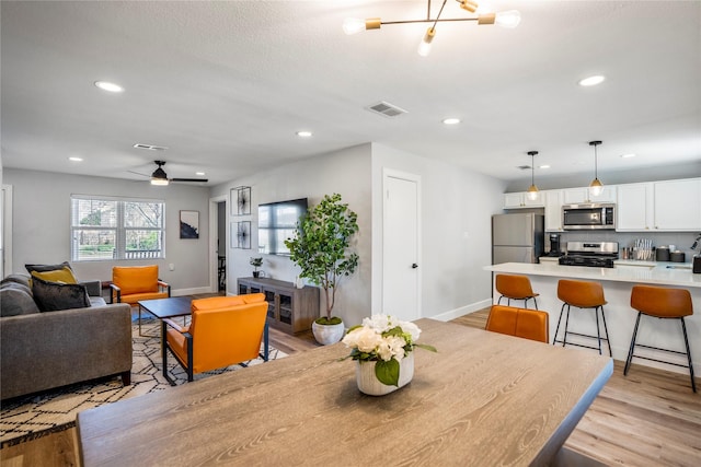 3814 Seabrook St, Houston, TX 77021 - dining area featuring light wood finished floors, baseboards, recessed lighting, and ceiling fan