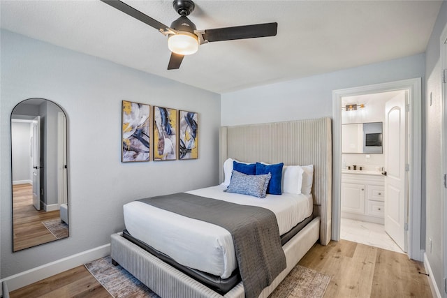 3814 Seabrook St, Houston, TX 77021 - bedroom featuring light wood finished floors, ensuite bath, baseboards, and ceiling fan