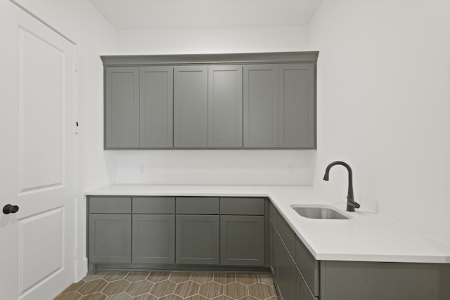 1827 Chantilly Ln, Houston, TX 77018 - kitchen featuring gray cabinetry, a sink, light countertops, and a peninsula