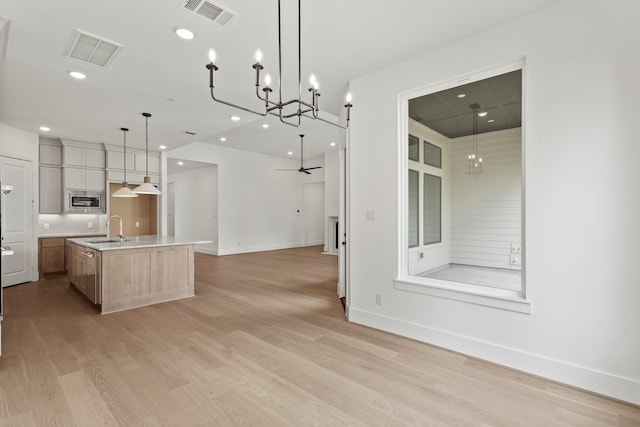 1827 Chantilly Ln, Houston, TX 77018 - kitchen featuring a sink, open floor plan, stainless steel microwave, light wood finished floors, and recessed lighting