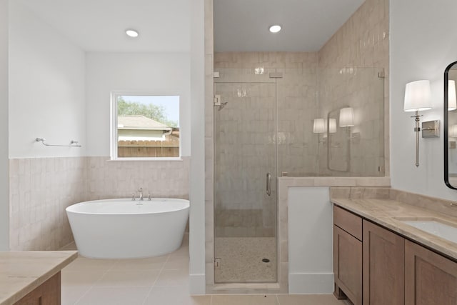 1827 Chantilly Ln, Houston, TX 77018 - full bathroom with vanity, a shower stall, a freestanding bath, tile patterned floors, and tile walls