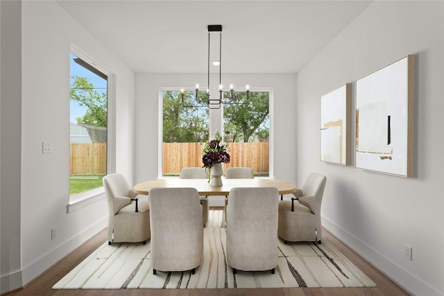 1827 Chantilly Ln, Houston, TX 77018 - dining area with baseboards, a chandelier, and light wood finished floors