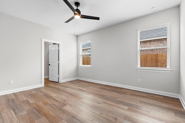 910 Whispering Winds Dr, Beasley, TX 77417 - unfurnished bedroom with light wood-style flooring, baseboards, and ceiling fan