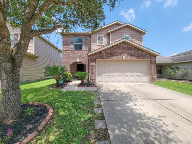 26118 Flinton Dr, Richmond, TX 77406 - traditional-style home with brick siding, concrete driveway, a garage, and a front yard