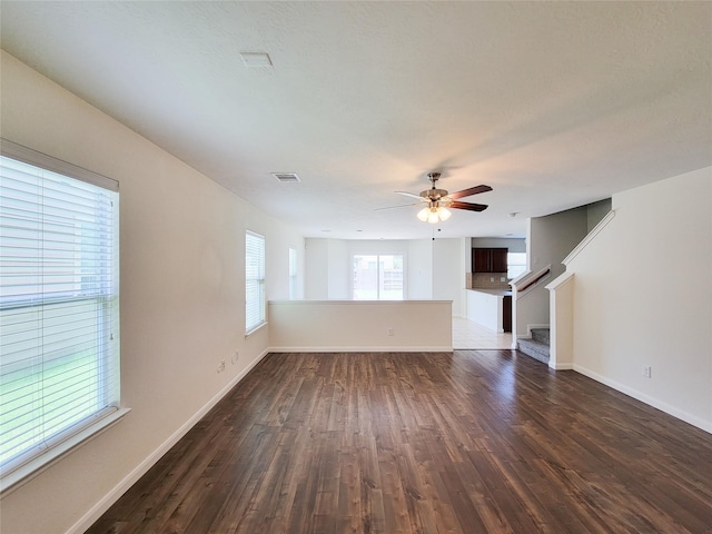 26118 Flinton Dr, Richmond, TX 77406 - unfurnished living room with dark wood finished floors, stairway, a ceiling fan, and baseboards