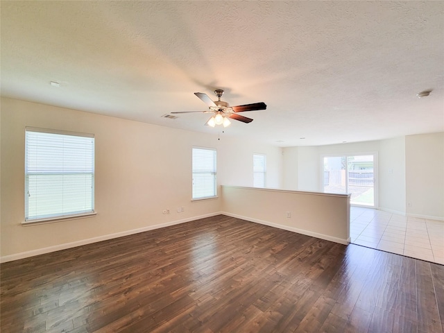 26118 Flinton Dr, Richmond, TX 77406 - spare room with plenty of natural light, wood finished floors, a ceiling fan, baseboards, and a textured ceiling