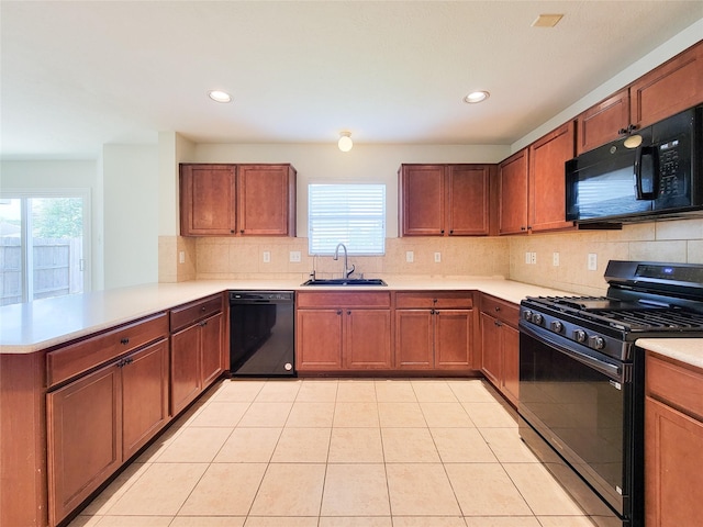 26118 Flinton Dr, Richmond, TX 77406 - kitchen featuring black appliances, a sink, a peninsula, plenty of natural light, and recessed lighting
