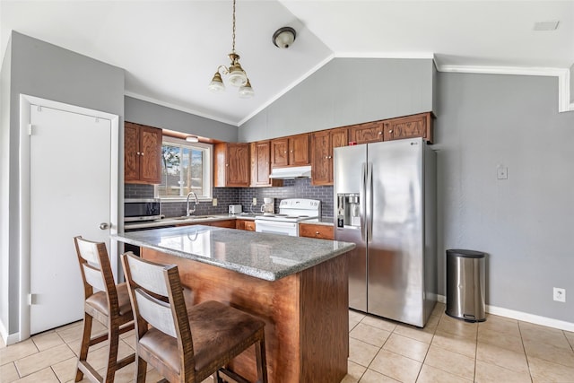 7730 Wickersham Pl, Beaumont, TX 77706 - kitchen with stainless steel appliances, light tile patterned flooring, backsplash, vaulted ceiling, and a sink
