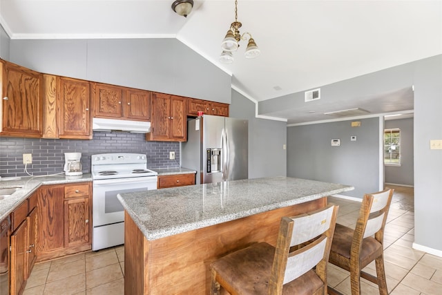 7730 Wickersham Pl, Beaumont, TX 77706 - kitchen featuring stainless steel fridge, white electric range oven, under cabinet range hood, light tile patterned floors, and backsplash