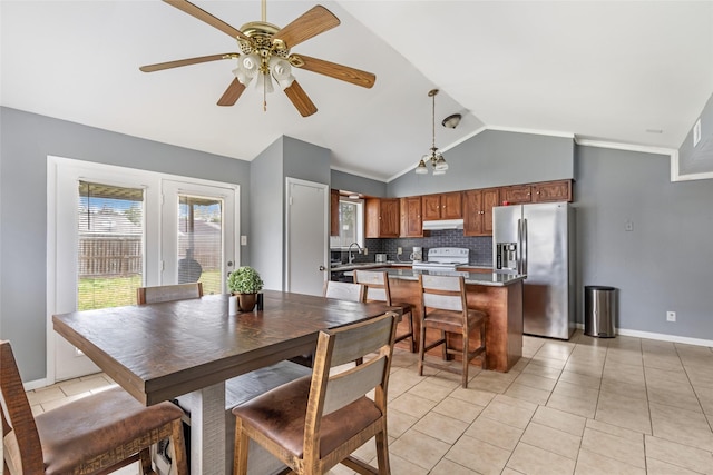 7730 Wickersham Pl, Beaumont, TX 77706 - dining space featuring vaulted ceiling, light tile patterned floors, ceiling fan, and baseboards
