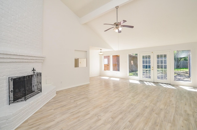 unfurnished living room featuring high vaulted ceiling, french doors, beamed ceiling, a fireplace, and light wood-style floors