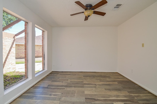 unfurnished room featuring wood finished floors, ceiling fan, and baseboards