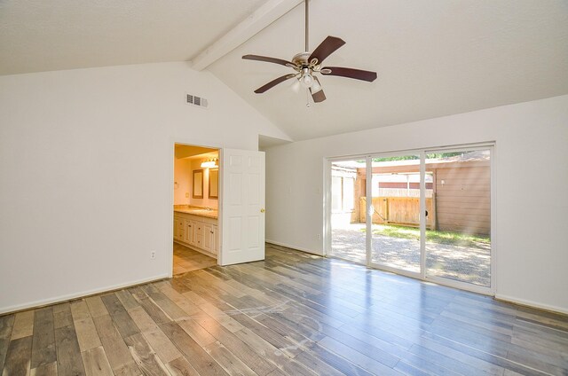 spare room with beam ceiling, wood finished floors, high vaulted ceiling, ceiling fan, and a sink