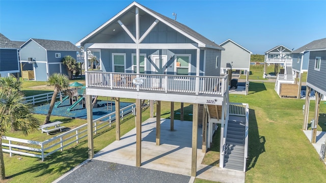 1079 Cedar Ln, Gilchrist, TX 77617 - view of front of home featuring a carport, board and batten siding, and driveway