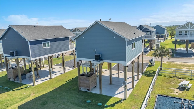 1079 Cedar Ln, Gilchrist, TX 77617 - rear view of property featuring a residential view, a patio, a shingled roof, and central AC unit