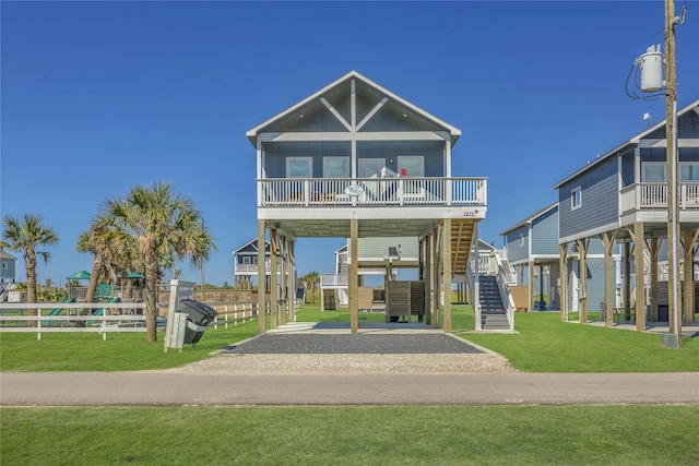 1079 Cedar Ln, Gilchrist, TX 77617 - raised beach house featuring a carport, dirt driveway, and stairs