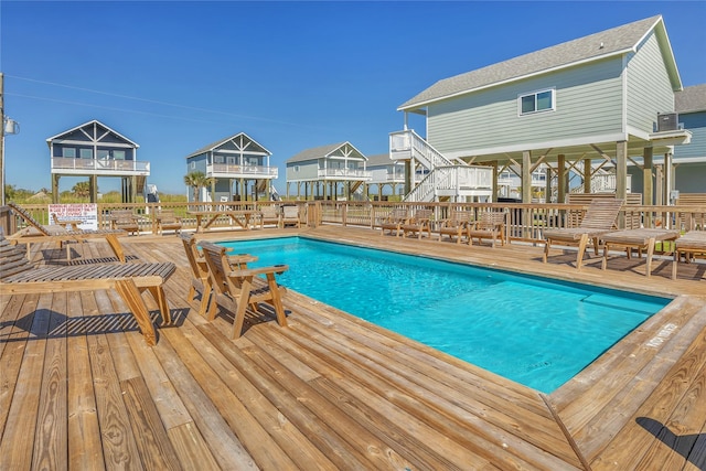1079 Cedar Ln, Gilchrist, TX 77617 - outdoor pool featuring a wooden deck and stairs