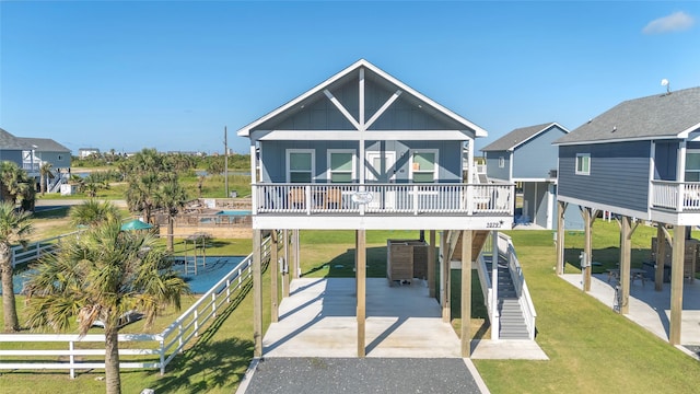 1079 Cedar Ln, Gilchrist, TX 77617 - view of front of house featuring a carport, driveway, board and batten siding, and stairs