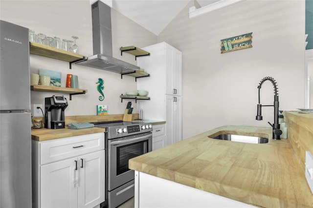 1079 Cedar Ln, Gilchrist, TX 77617 - kitchen featuring open shelves, wall chimney exhaust hood, butcher block counters, stainless steel appliances, and a sink