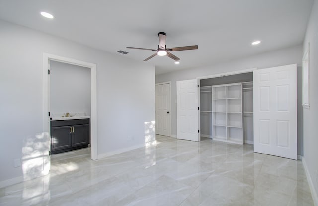 unfurnished bedroom featuring light marble finish flooring, a sink, recessed lighting, baseboards, and connected bathroom