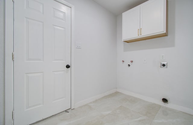 clothes washing area featuring hookup for an electric dryer, cabinet space, baseboards, and hookup for a washing machine