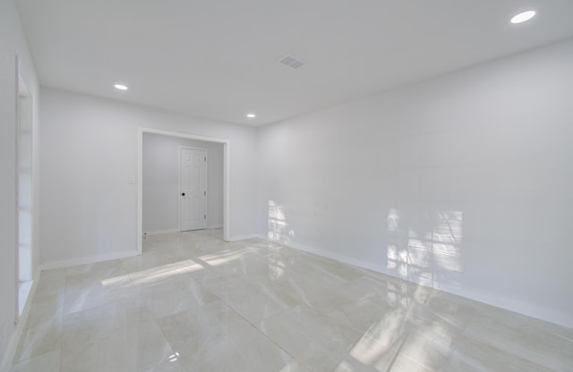 unfurnished room with recessed lighting and baseboards