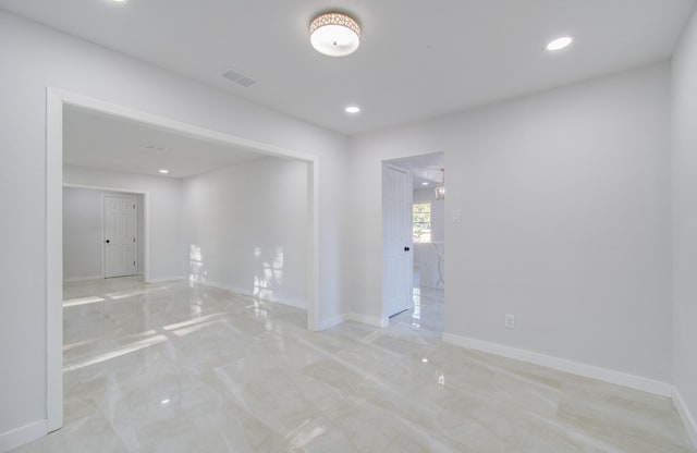 unfurnished room with light marble finish flooring, baseboards, and recessed lighting