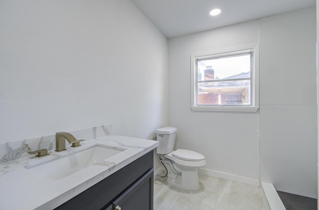 bathroom featuring toilet, vanity, marble finish flooring, recessed lighting, and baseboards