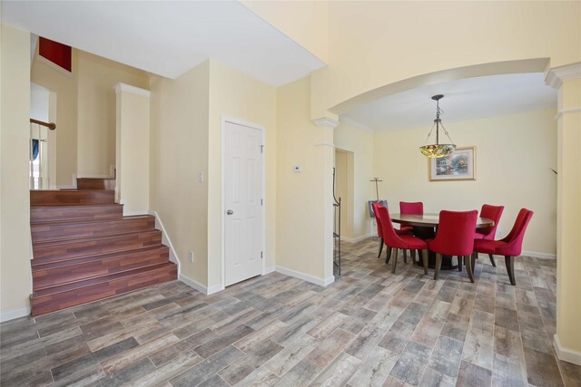 17906 Camden Oaks Ln, Richmond, TX 77407 - dining area with wood finished floors, stairway, arched walkways, and baseboards