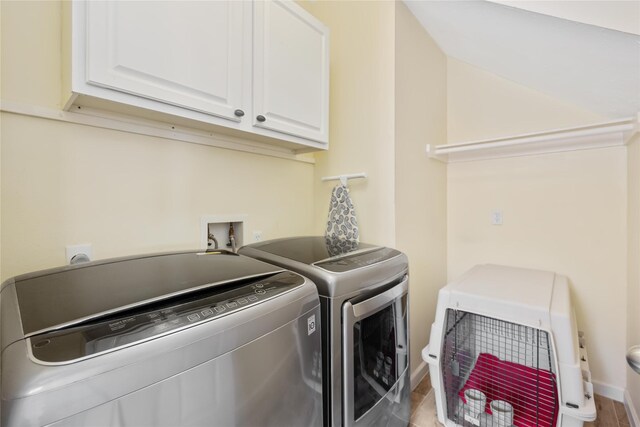 17906 Camden Oaks Ln, Richmond, TX 77407 - washroom featuring cabinet space, washer and dryer, wood finished floors, and baseboards