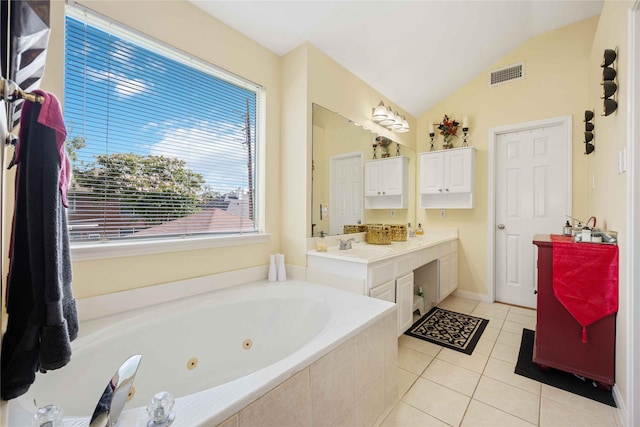 17906 Camden Oaks Ln, Richmond, TX 77407 - full bathroom with double vanity, a jetted tub, tile patterned flooring, vaulted ceiling, and baseboards