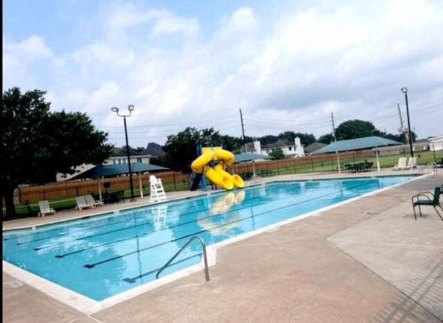 17906 Camden Oaks Ln, Richmond, TX 77407 - community pool with a water slide and a patio area