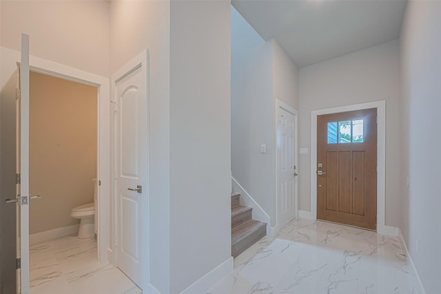 7207 Force St, Houston, TX 77020 - foyer featuring marble look tiles, baseboards, and stairs