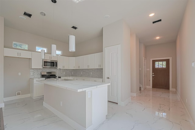7207 Force St, Houston, TX 77020 - kitchen featuring appliances with stainless steel finishes, light marble finish floors, a sink, baseboards, and recessed lighting