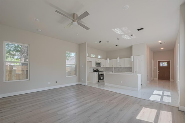 7207 Force St, Houston, TX 77020 - unfurnished living room with healthy amount of natural light, light wood finished floors, a ceiling fan, baseboards, and recessed lighting