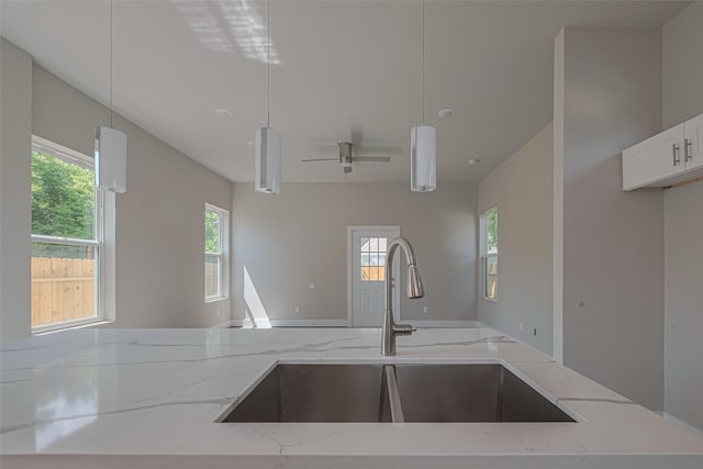 7207 Force St, Houston, TX 77020 - kitchen with a sink, light stone counters, decorative light fixtures, and open floor plan