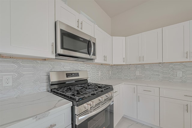 7207 Force St, Houston, TX 77020 - kitchen featuring stainless steel appliances, light stone counters, white cabinets, and backsplash