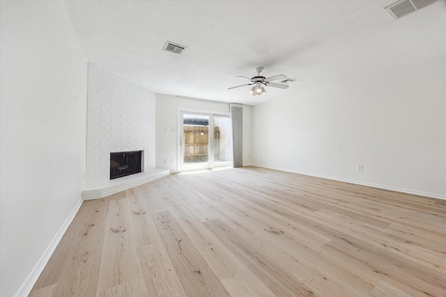 2515 Bering Dr Unit 11, Houston, TX 77057 - unfurnished living room with light wood-type flooring, a ceiling fan, and a fireplace
