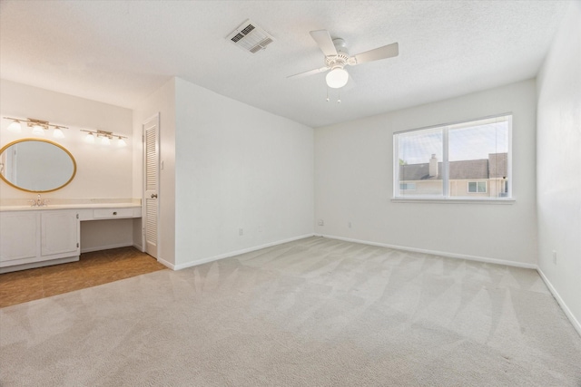 2515 Bering Dr Unit 11, Houston, TX 77057 - unfurnished bedroom with light carpet, a ceiling fan, a closet, and a desk