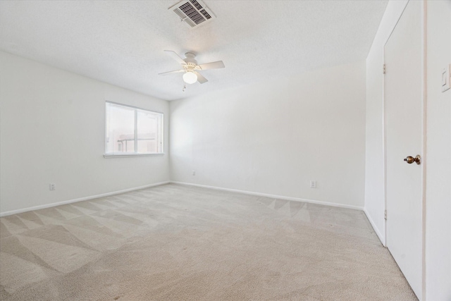 2515 Bering Dr Unit 11, Houston, TX 77057 - spare room featuring a ceiling fan, light colored carpet, and baseboards