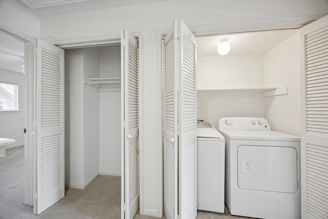 2515 Bering Dr Unit 11, Houston, TX 77057 - washroom with washing machine and dryer and light carpet