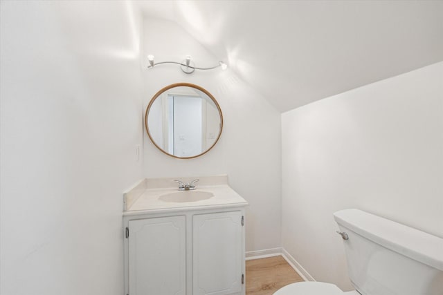 2515 Bering Dr Unit 11, Houston, TX 77057 - half bathroom featuring vanity, lofted ceiling, and wood finished floors