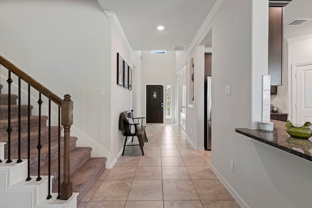 315 Cadela Dr, Montgomery, TX 77316 - corridor with stairs, light tile patterned floors, baseboards, and crown molding