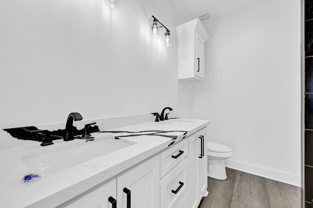 116 York St, South Houston, TX 77587 - full bathroom featuring toilet, wood finished floors, double vanity, and baseboards