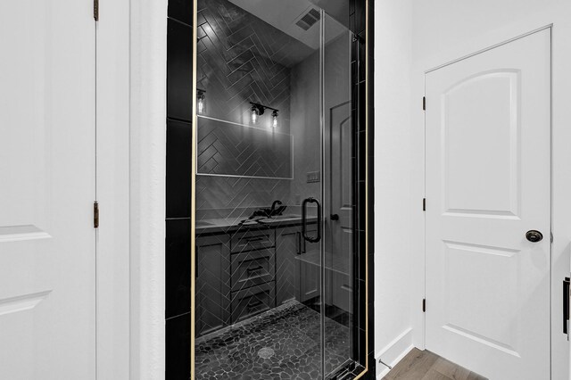 116 York St, South Houston, TX 77587 - full bathroom featuring a stall shower and wood finished floors