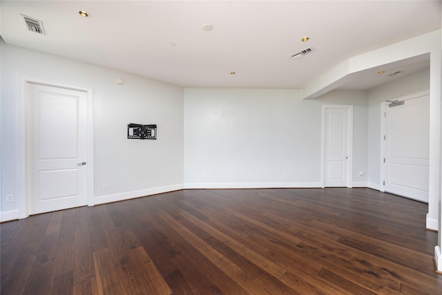 spare room with dark wood-style floors and baseboards