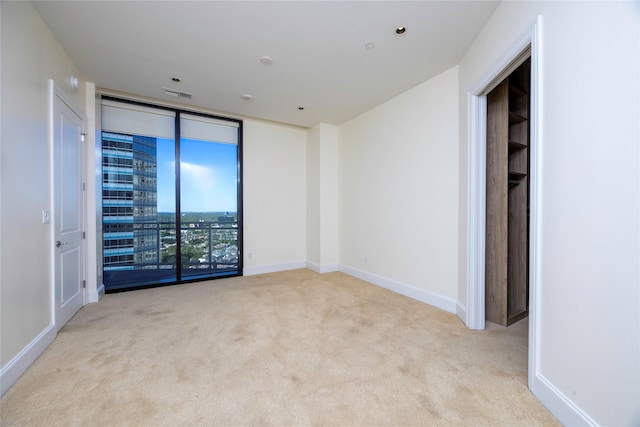 carpeted spare room featuring baseboards