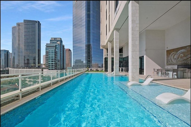 community pool featuring a skyline view