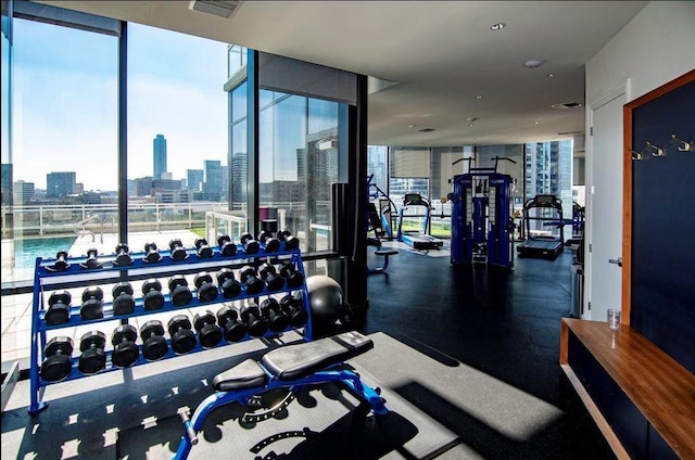 exercise room with a city view and expansive windows